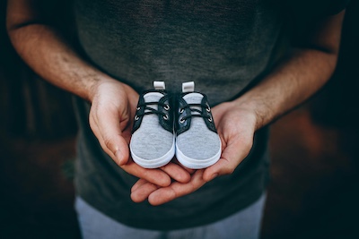 Helena Lopes from pexels.comhttps://www.pexels.com/photo/man-holding-baby-shoes-4409000/